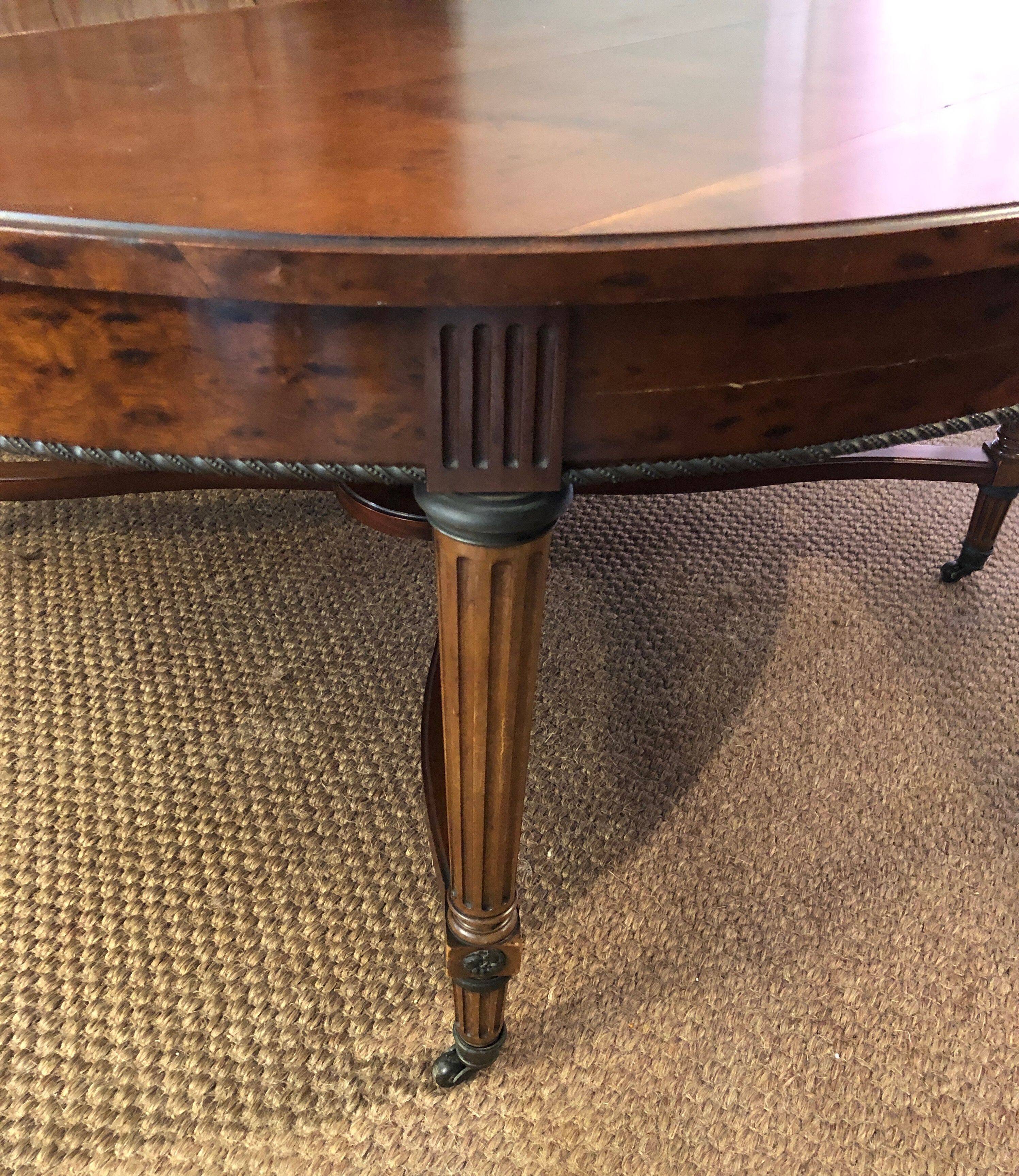 Important central pedestal table in mahogany, brass and bronze that can form a large dining table.