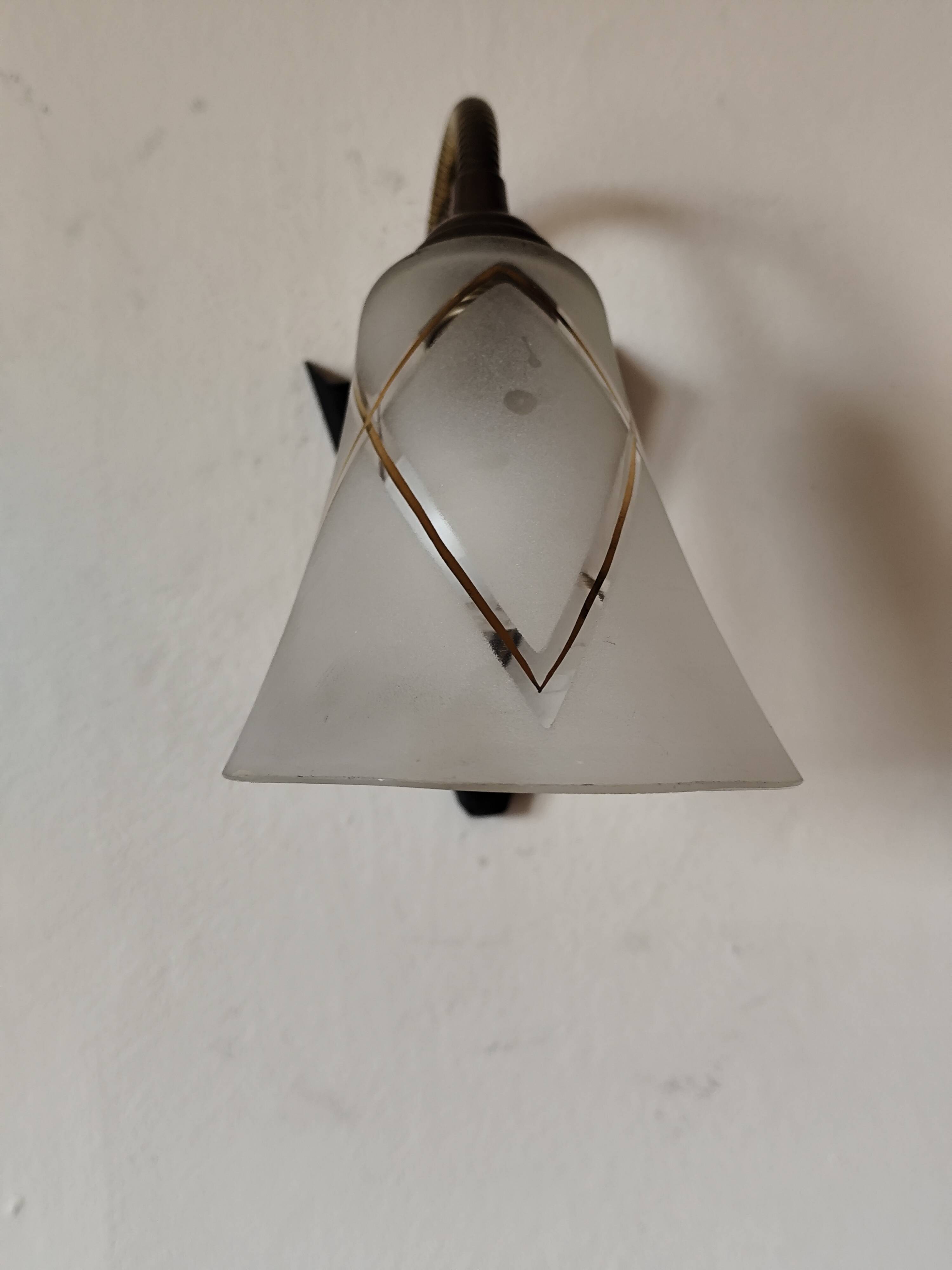 1950s wall lamp, metal, flexible brass stem and opaque shade.