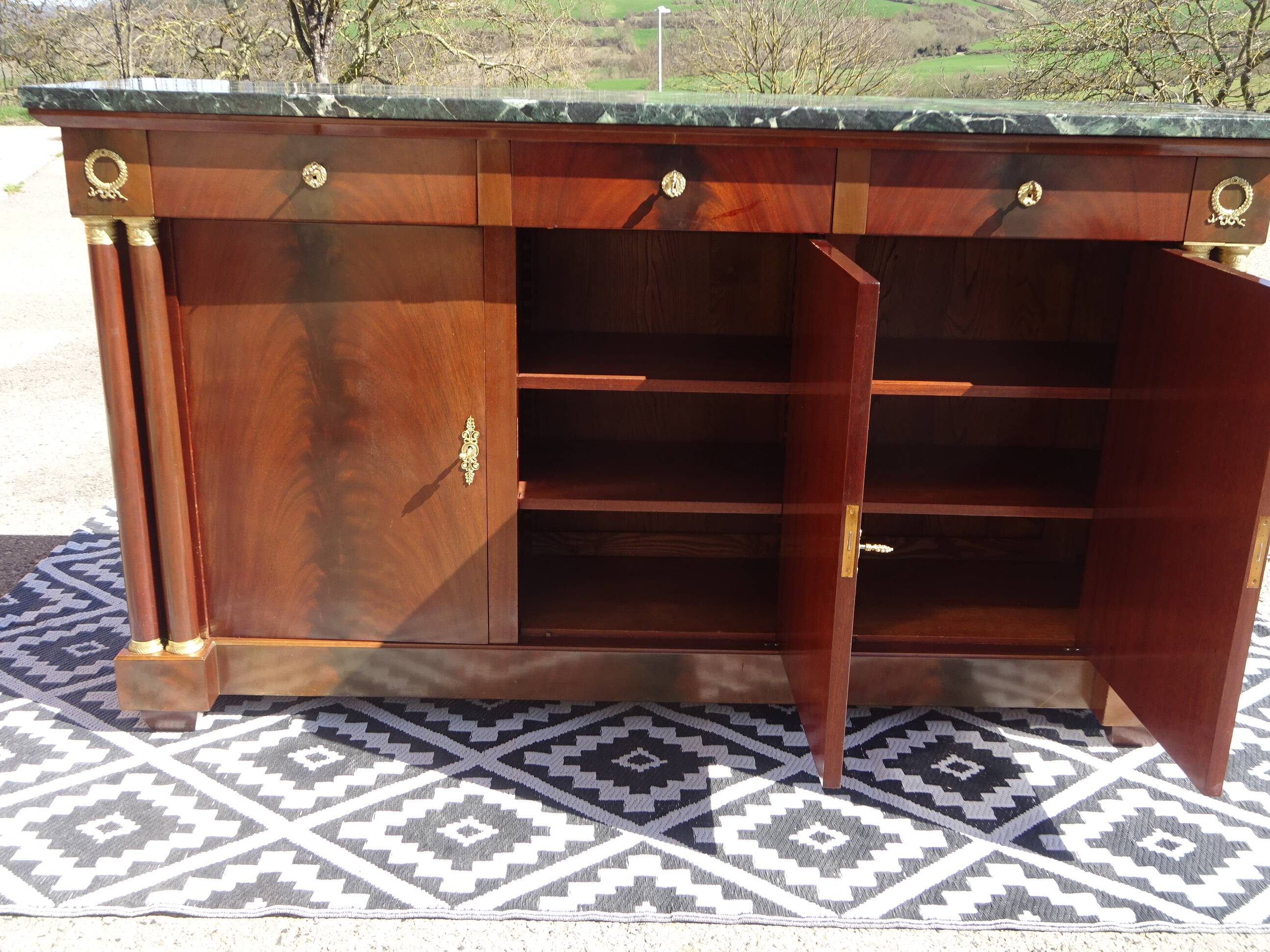 Flamed mahogany enfilade with sea green marble in Empire style.