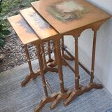 Sets of three nesting tables with painted landscape decorations in poplar.