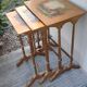 Sets of three nesting tables with painted landscape decorations in poplar.