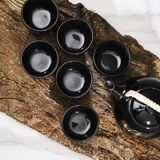 Japanese tea service, teapot and 6 cups, black, gold pattern.