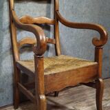 Empire armchair in solid walnut with woven straw seat.
