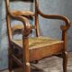 Empire armchair in solid walnut with woven straw seat.