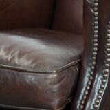 Sheepskin armchair with a classic finish and decorative studs.