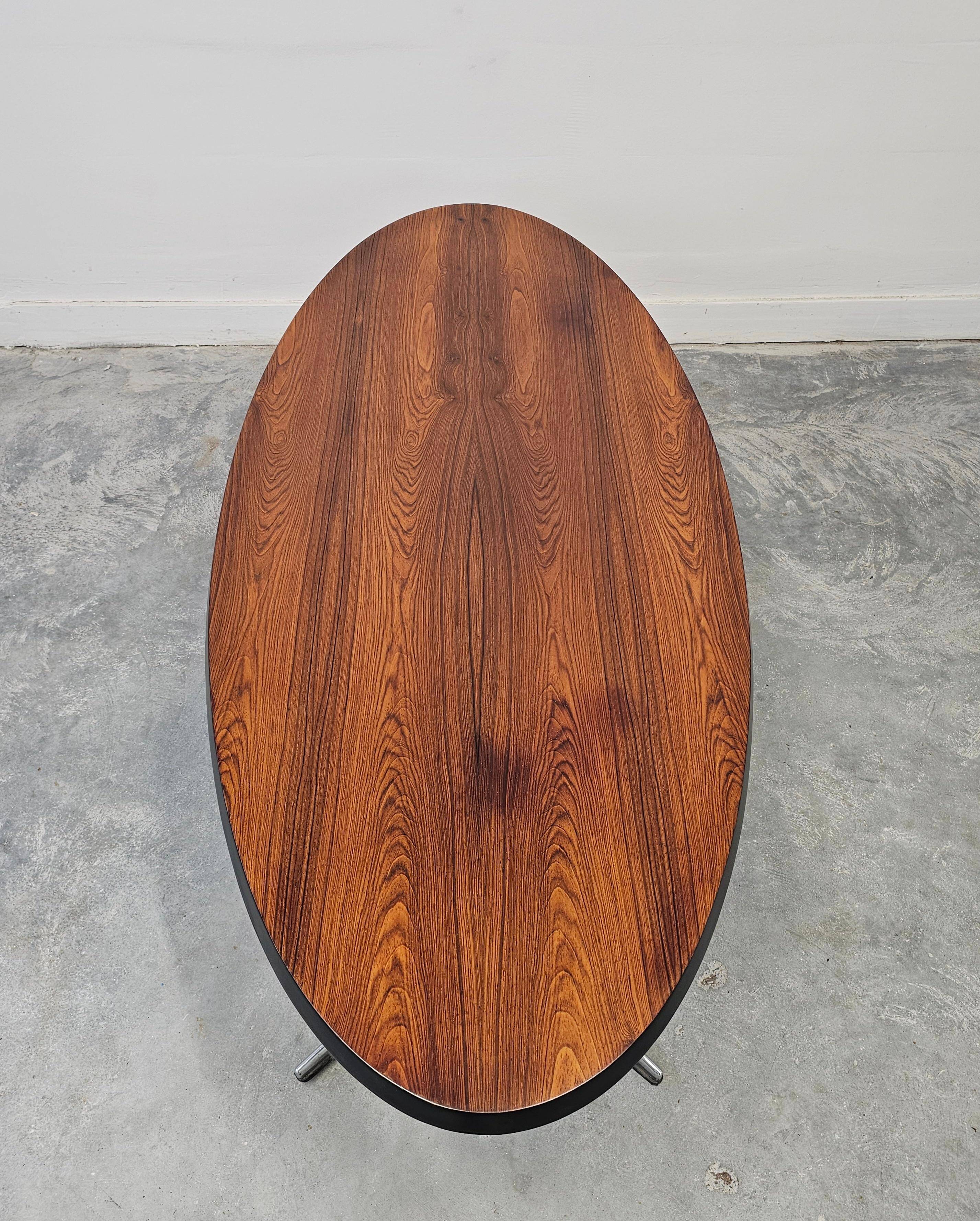 Danish Mid Century Modern oval coffee table with a teak top and chrome legs.