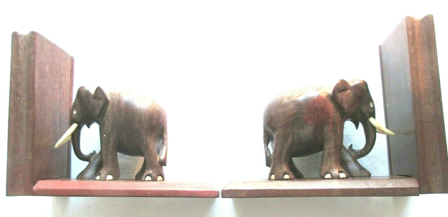 Art Deco bookends wooden elephants and bones on wooden terrace, book shape