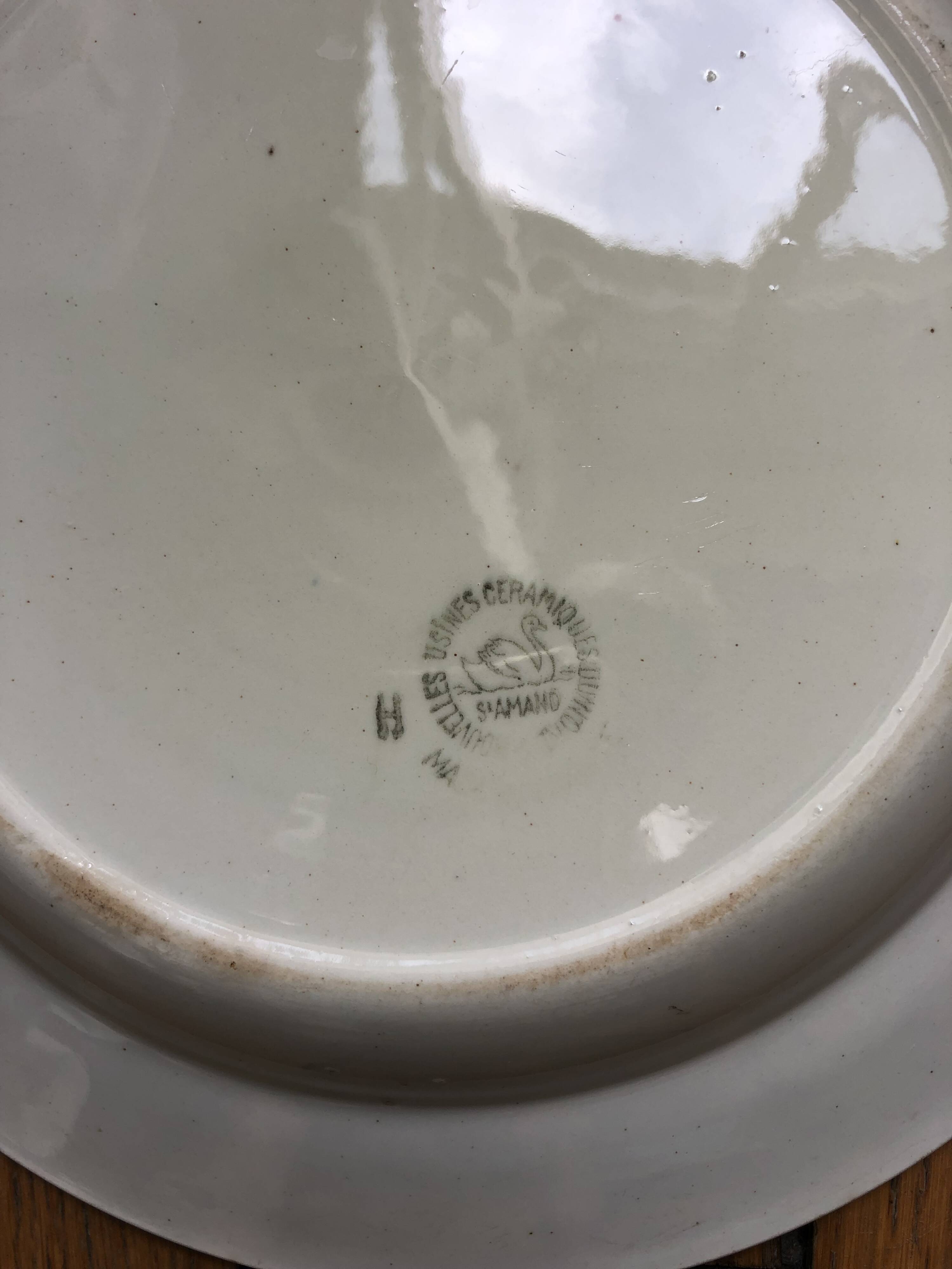 Vintage hollow serving dish with a decoration: marsh landscape.