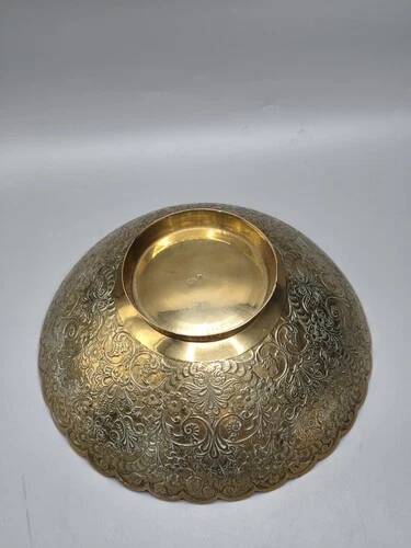 Engraved brass bowl from the mid-20th century with a scalloped edge.