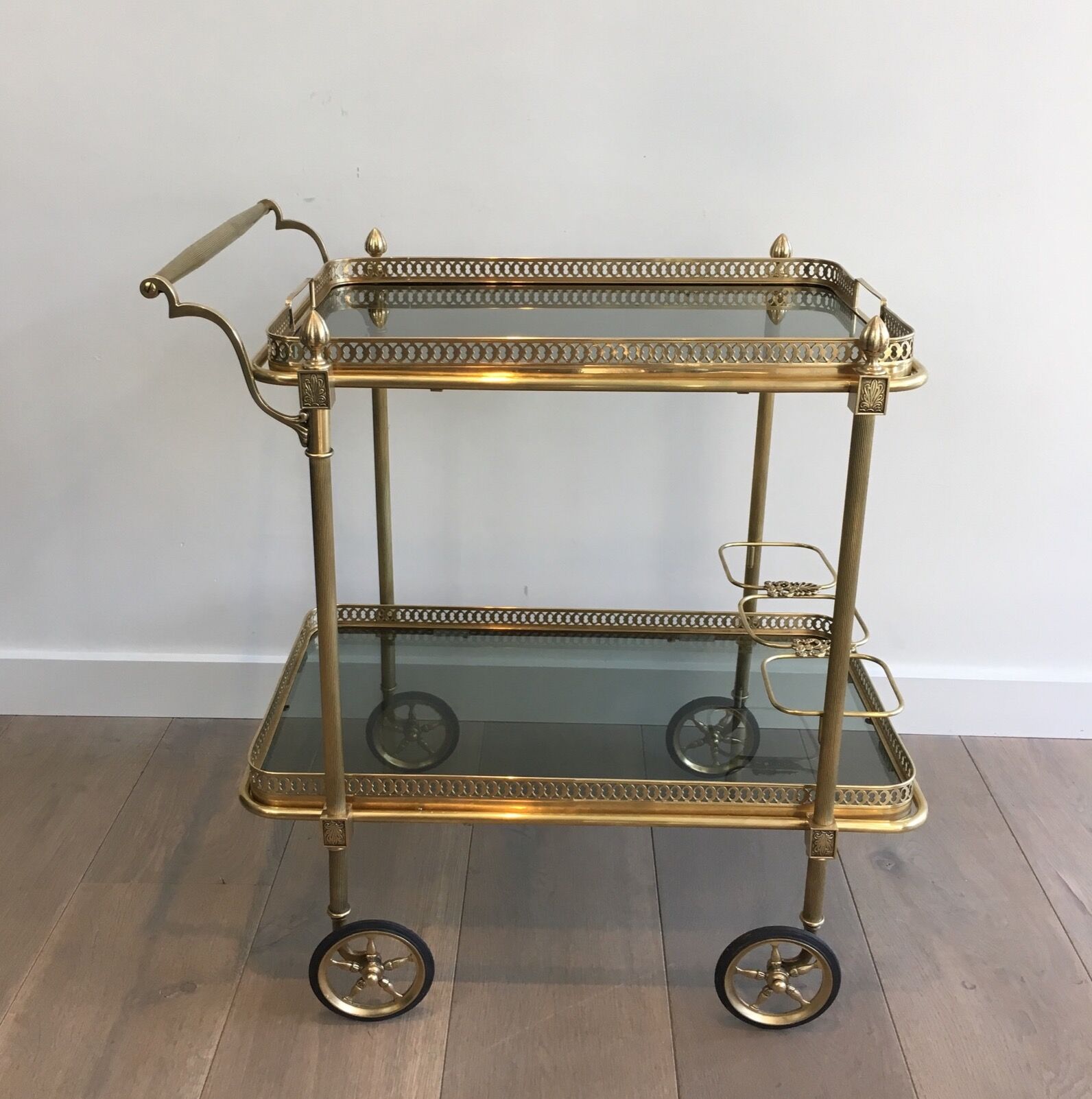 Neoclassical style rolling table in brass with blue glass tops