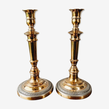 Duo of brass candle holders, chiseled feet