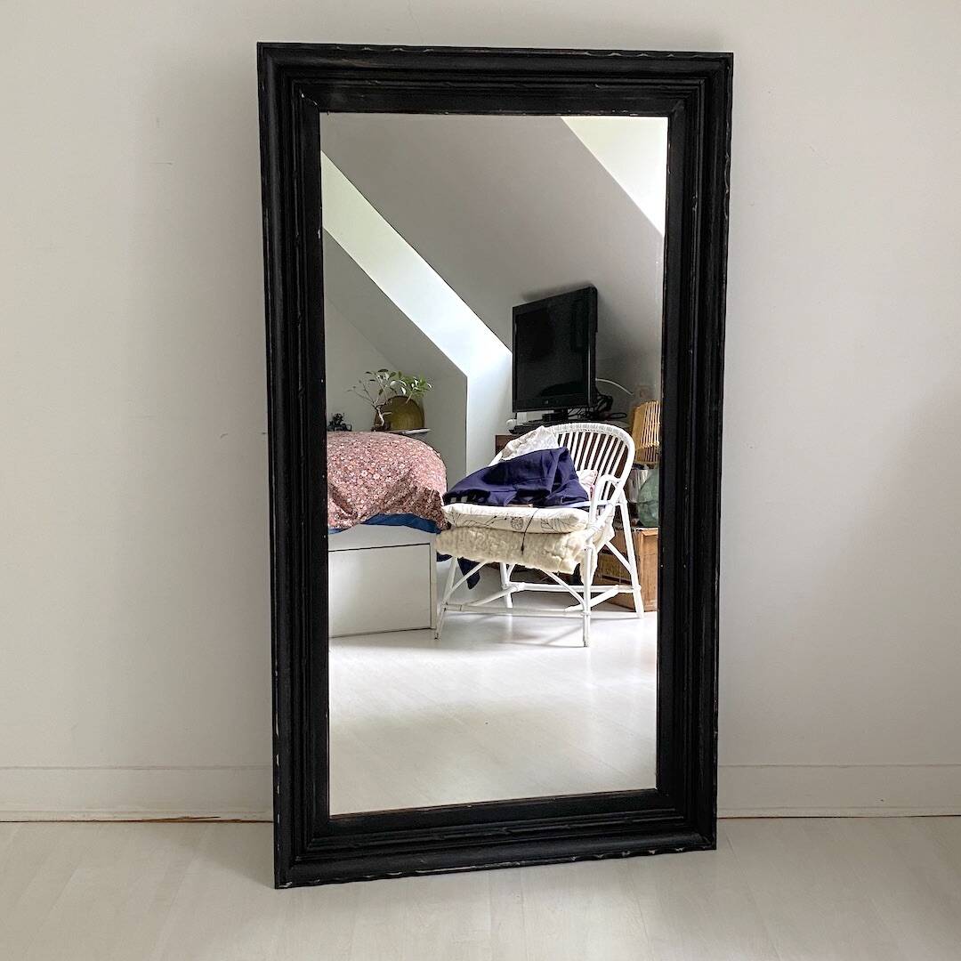 1950s mirror, matte black wood with a patina.