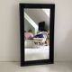 1950s mirror, matte black wood with a patina.