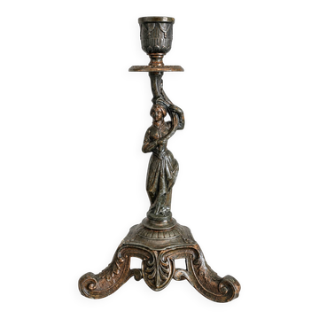 Antique 19th-century candlestick with a female figure.