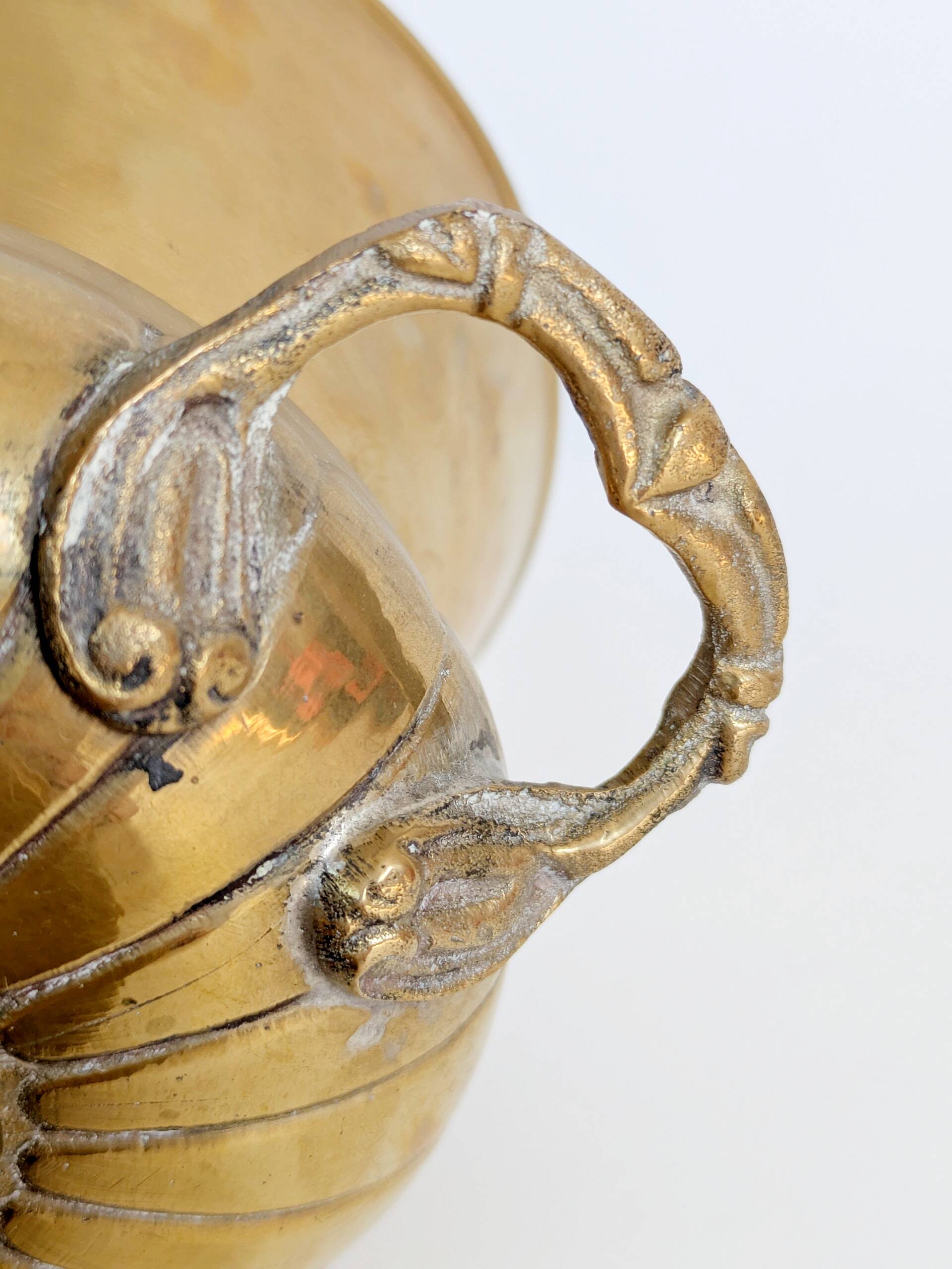 Vintage brass cache-pot on a stand with handles, classic decor.