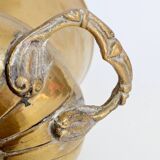 Vintage brass cache-pot on a stand with handles, classic decor.