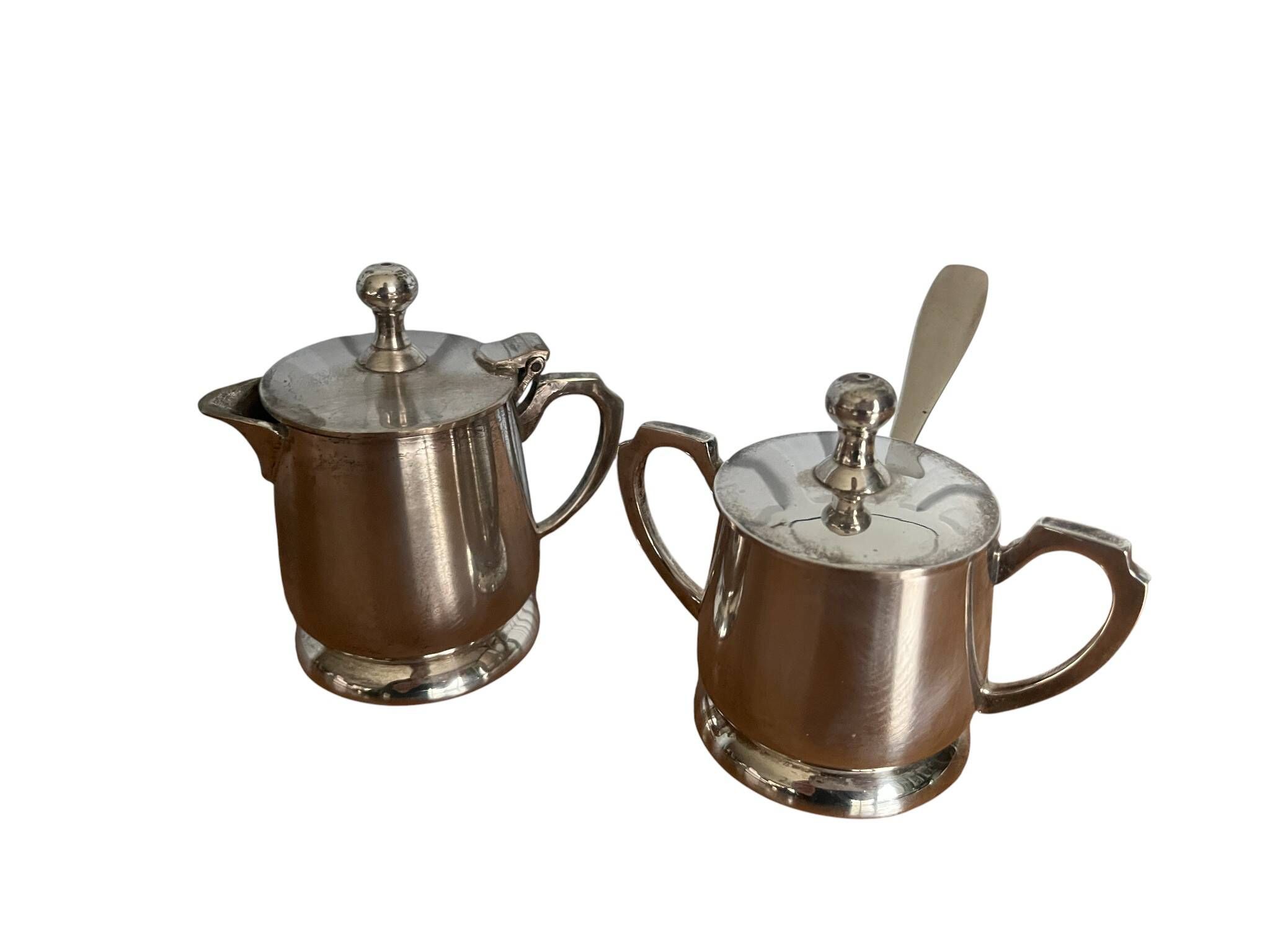 Two small silver-plated metal tea service pots from the 20th century.