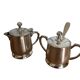 Two small silver-plated metal tea service pots from the 20th century.