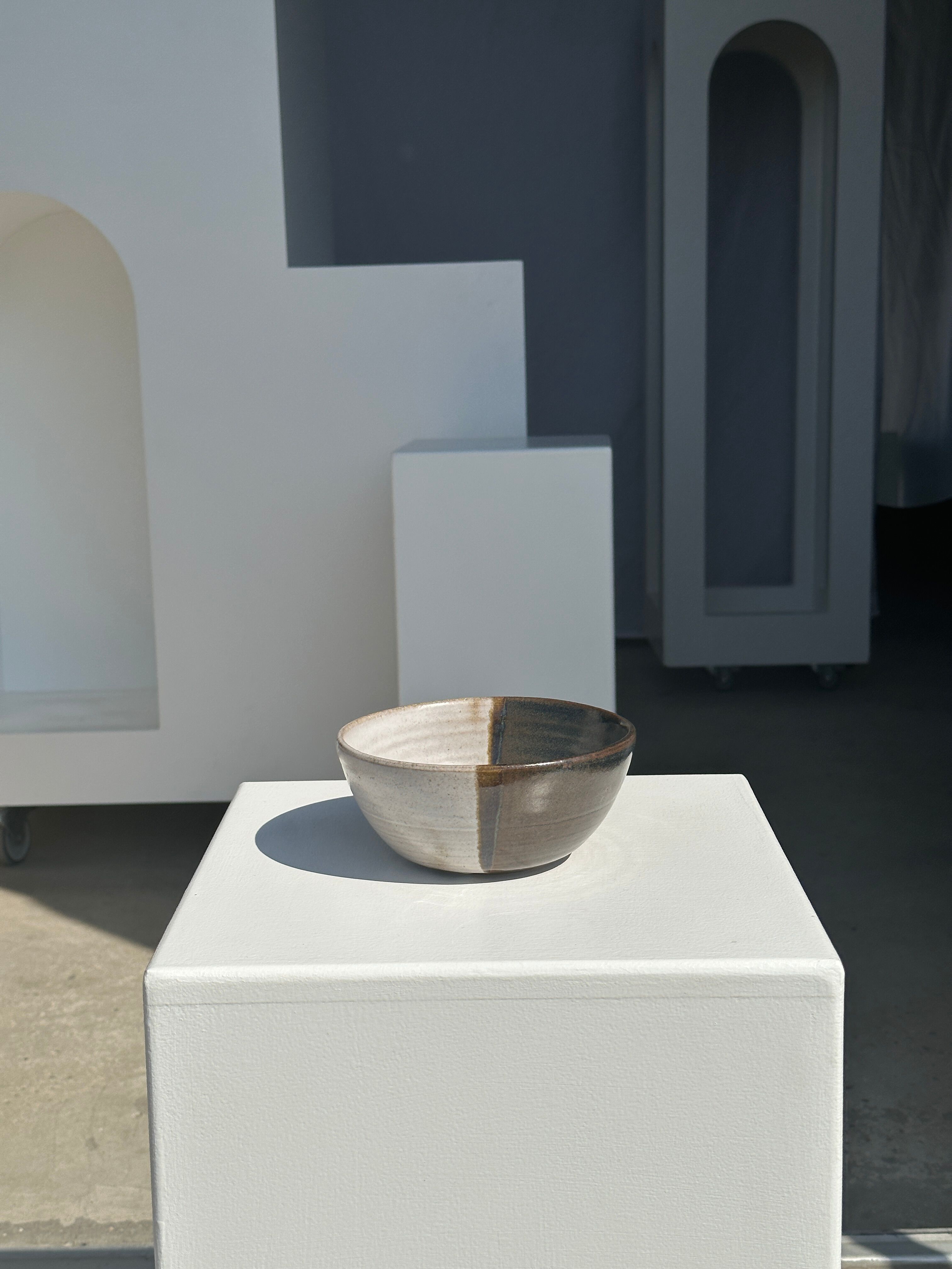 White and glossy brown two-tone ceramic bowl, matt earth