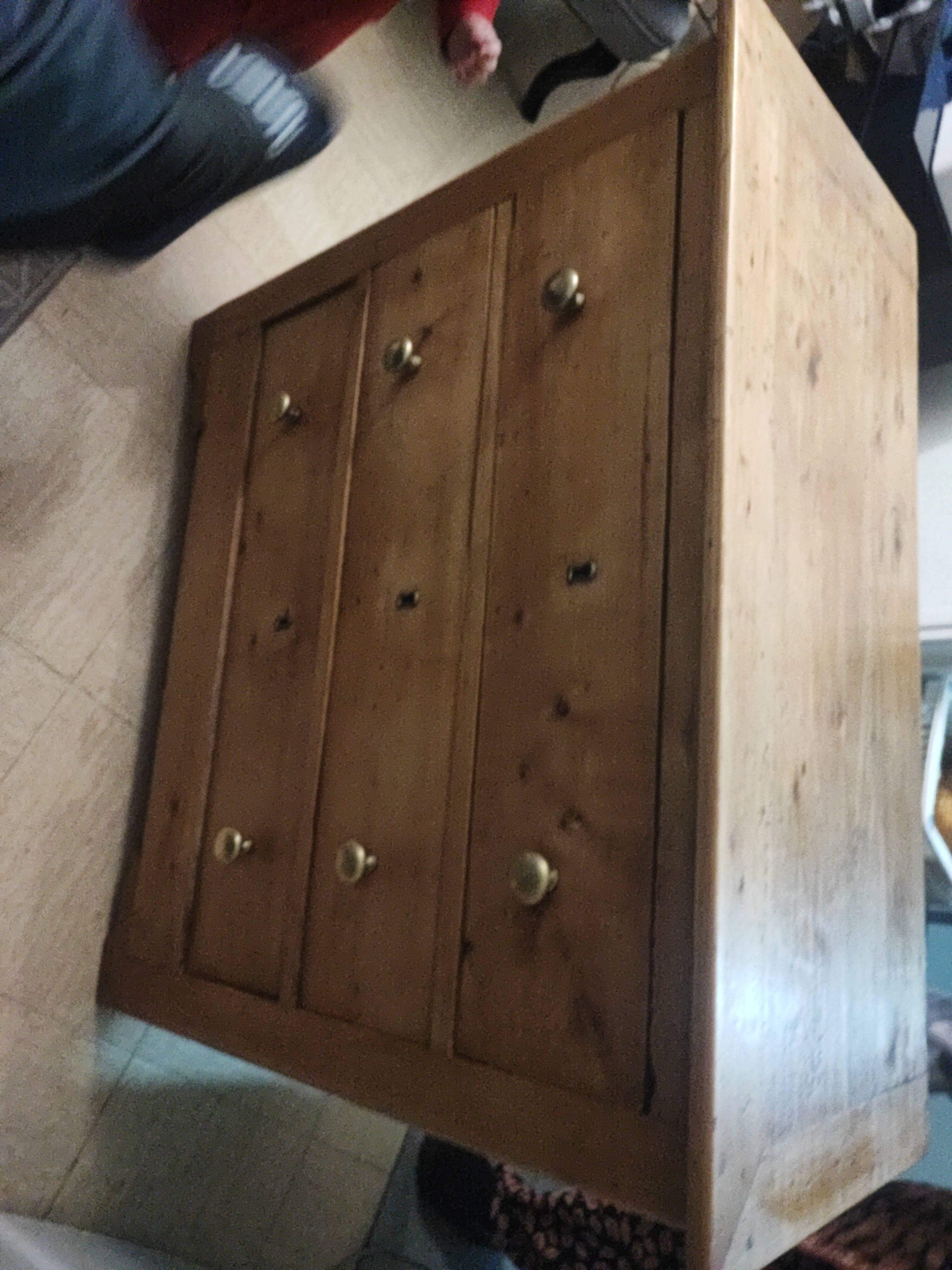 Rustic English pine chest of drawers with porcelain knobs.
