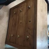 Rustic English pine chest of drawers with porcelain knobs.