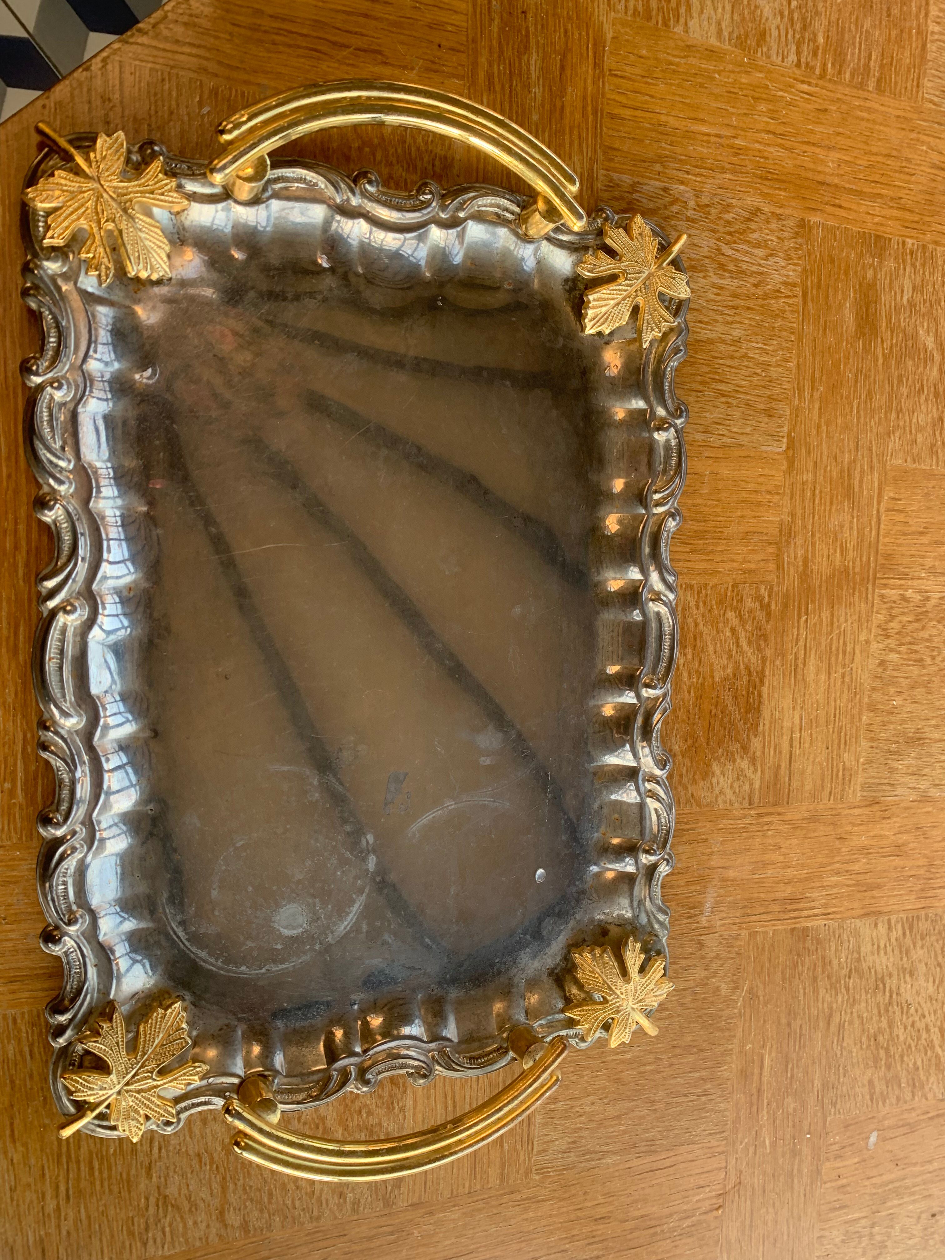 Silver metal top and decoration of foliage and handles in vintage brass