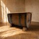 Oak barrel-shaped storage chest with black metal straps, 1930s-1940s.