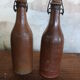 Set of 2 sandstone bottles with ceramic capsule