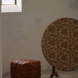 19th-century French round wine table with an adjustable top and floral textile surface.