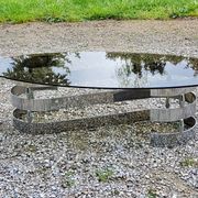 Oval coffee table of the 70s chromed metal base in s smoked glass top