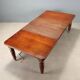 Antique extendable mahogany table with a crank mechanism, United Kingdom.