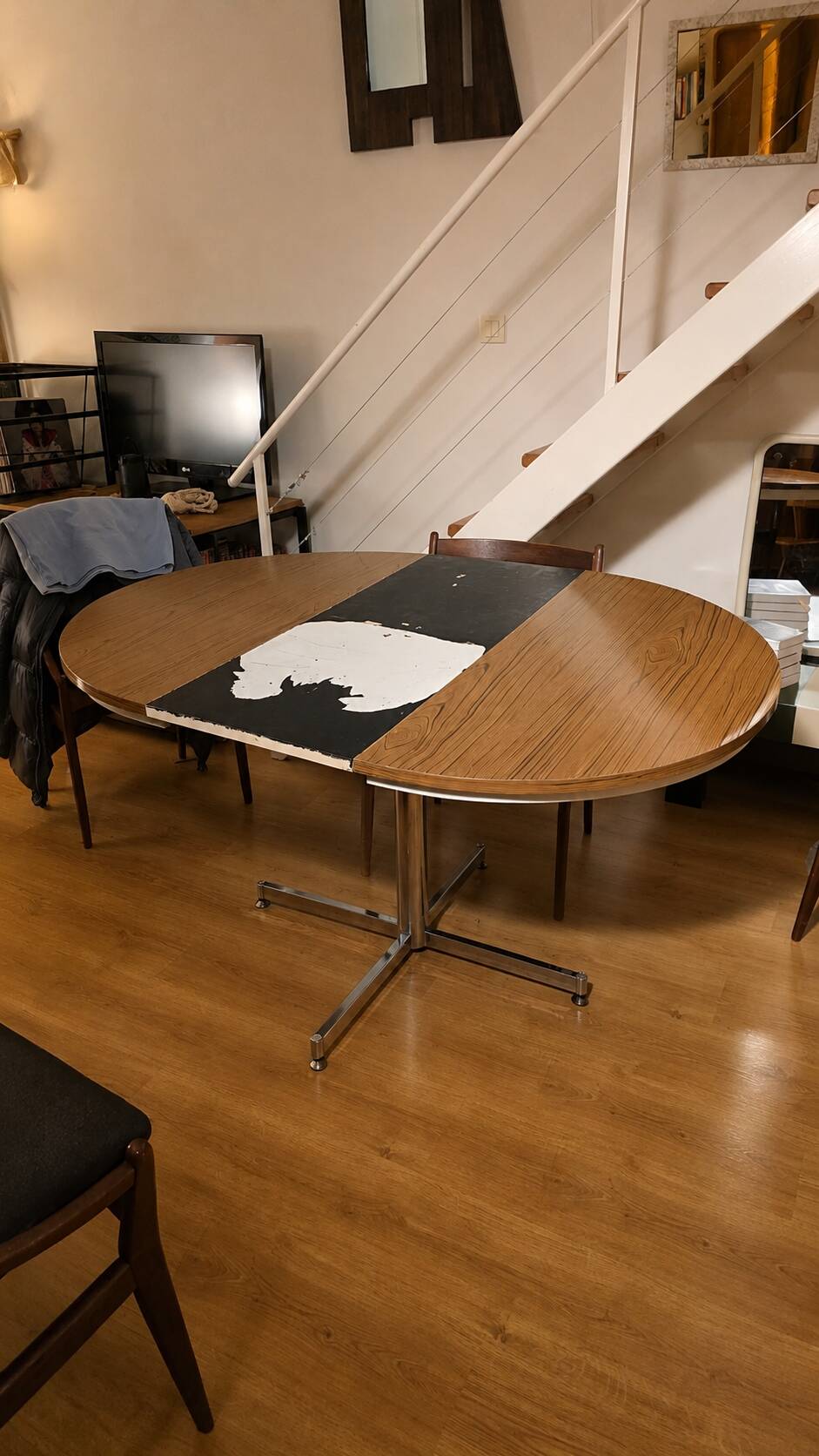Extendable round table with a space age vintage mid-century formica top.
