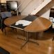 Extendable round table with a space age vintage mid-century formica top.