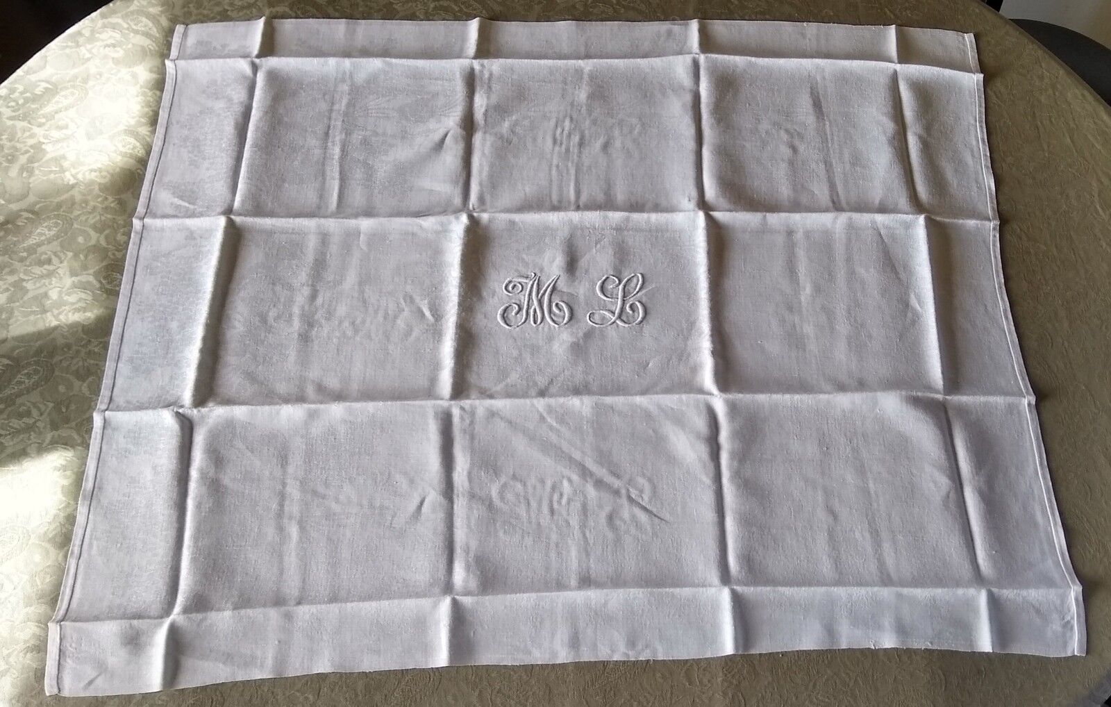 12 large antique damask towels with floral decoration and embroidered with the ML monogram