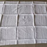 12 large antique damask towels with floral decoration and embroidered with the ML monogram
