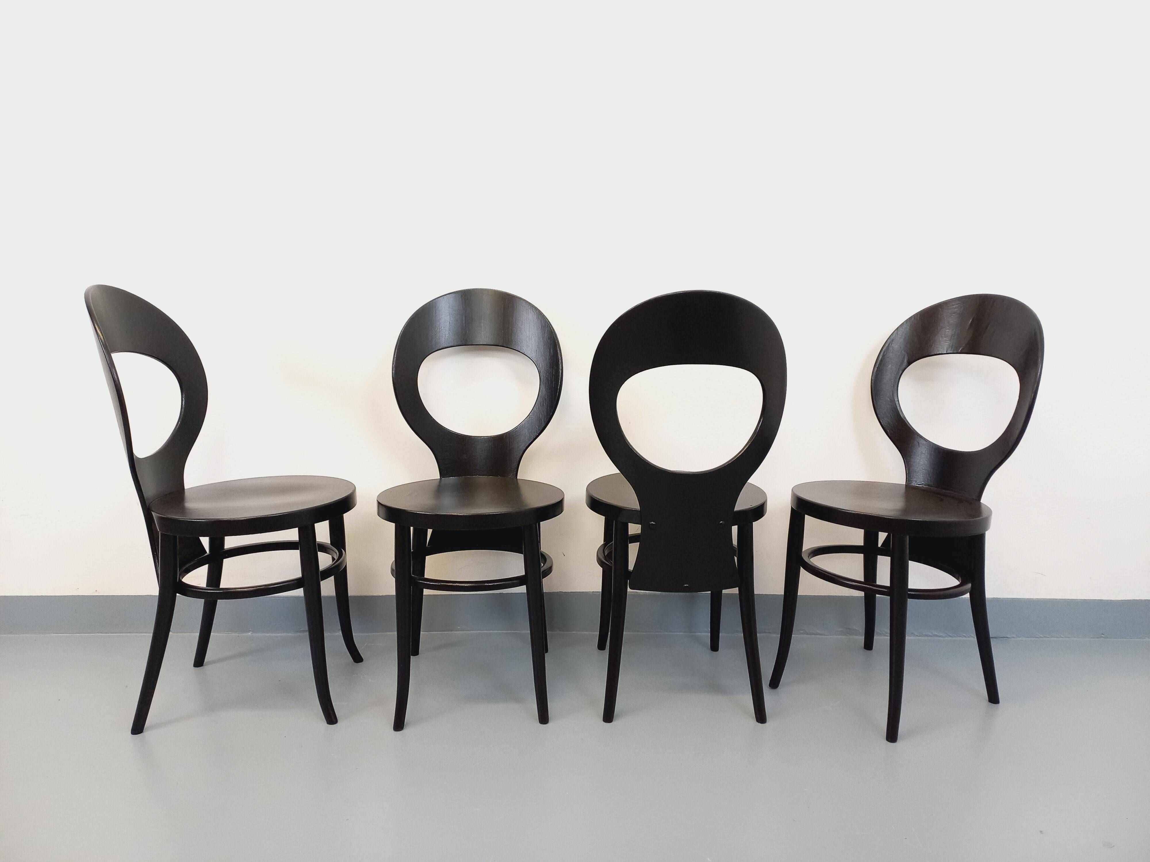 Set of 4 vintage Mouette chairs by Baumann in black wood from the 1960s.