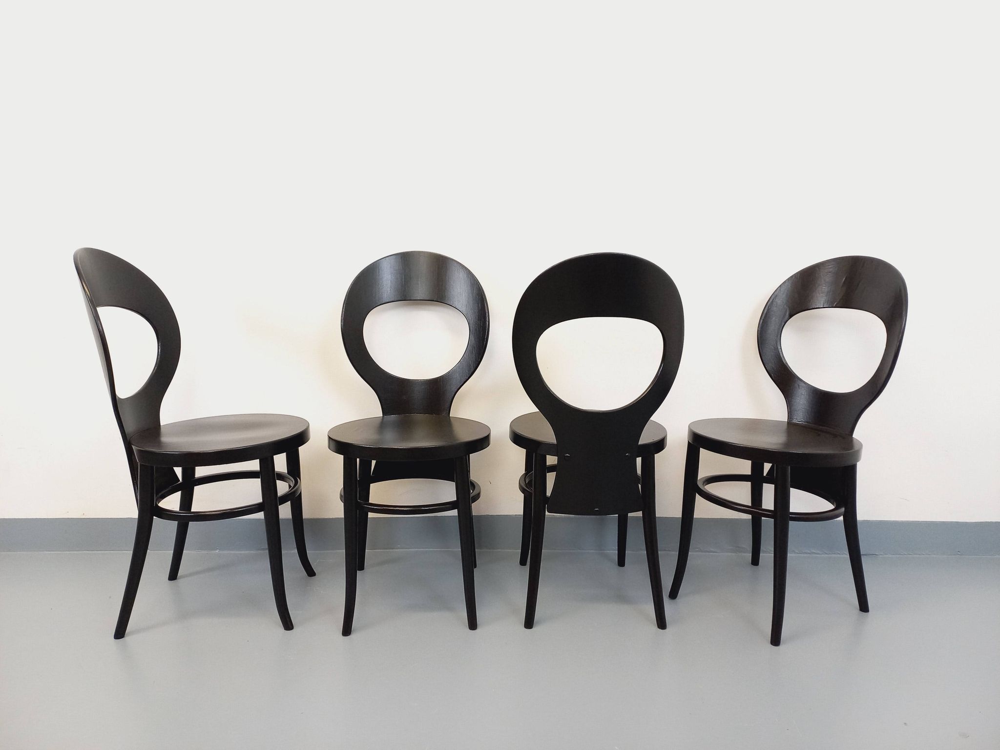 Set of 4 vintage Mouette chairs by Baumann in black wood from the 1960s.