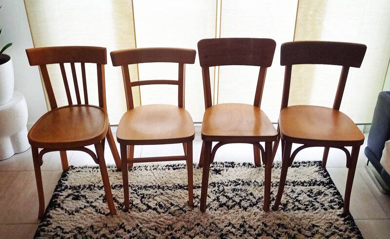 Set of 4 light wood bistro chairs stamped Baumann and Thonet.