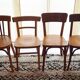 Set of 4 light wood bistro chairs stamped Baumann and Thonet.