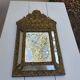 Miroir à parecloses en bois doré et métal repoussé