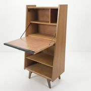 Vintage 1960s secretary desk with an angled design, light wood, and tapered legs.