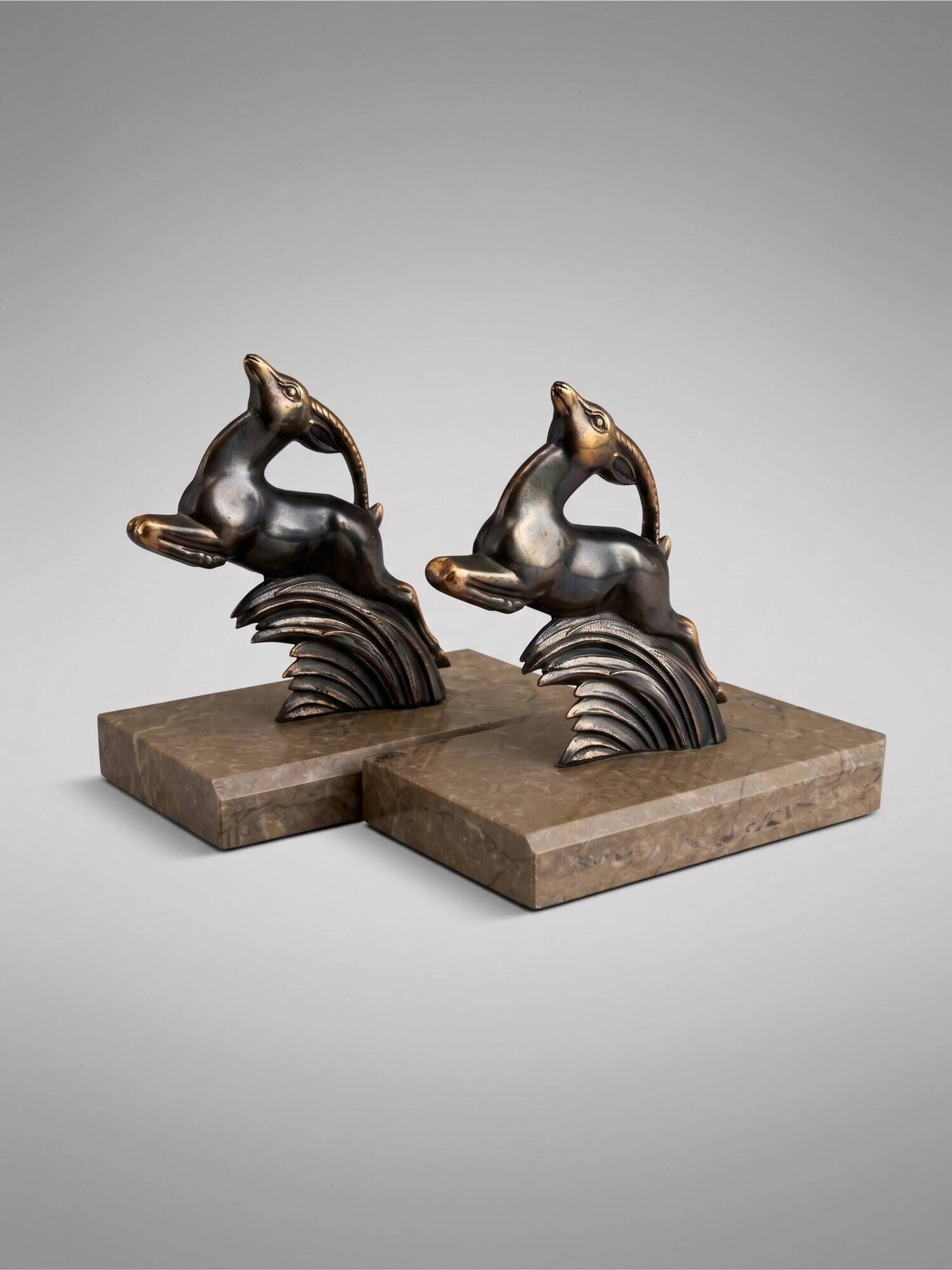 Art Deco bookends in patinated metal – animal pair – marble bases