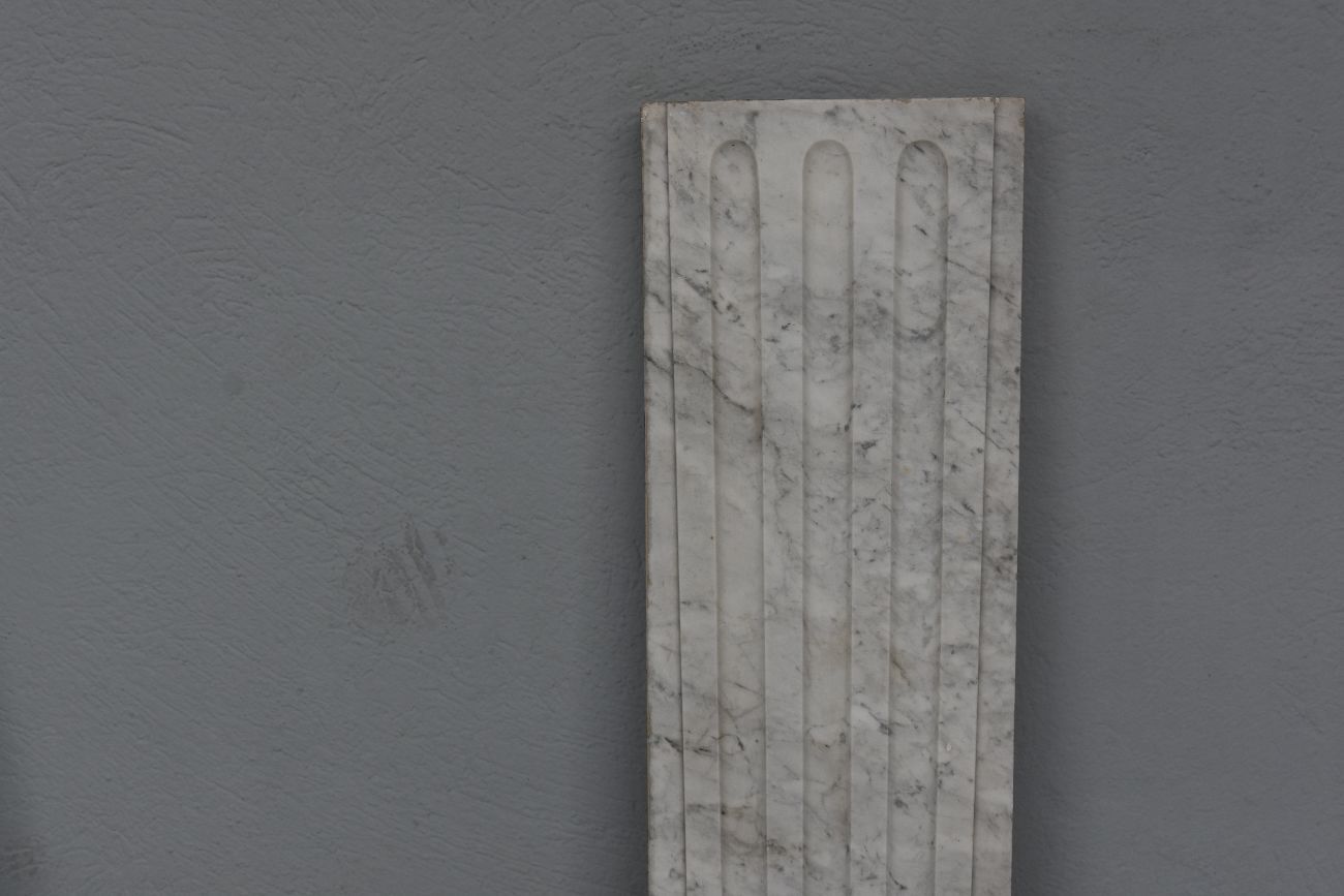 Old fireplace in white marble veined Louis XVI