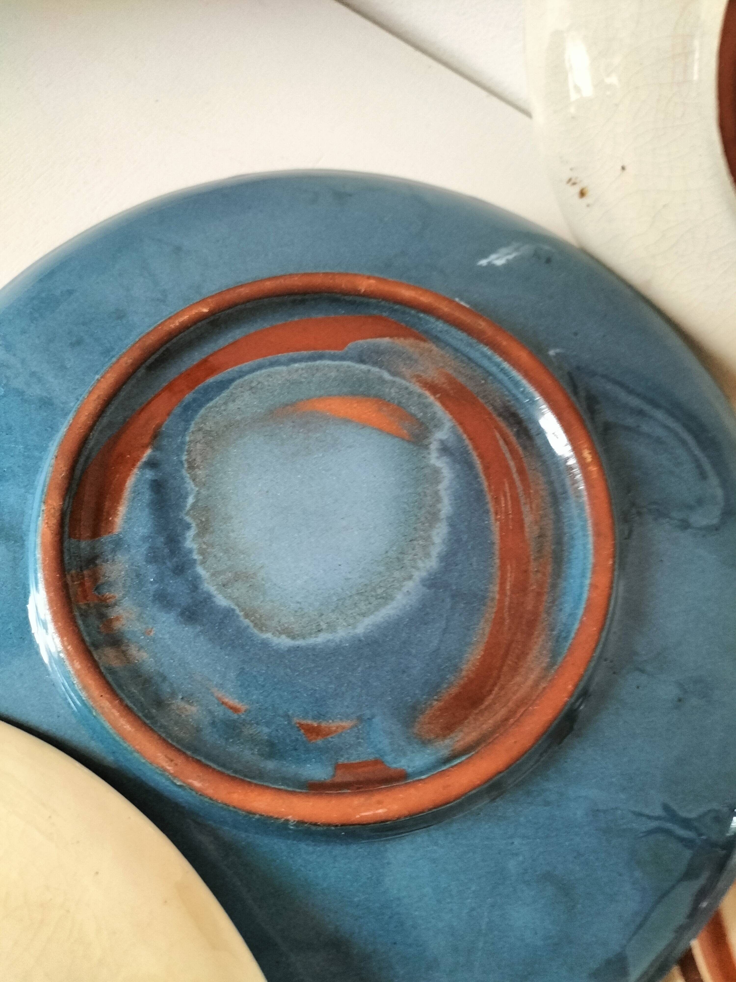 Set of 6 cream and grey-blue glazed earthenware plates.