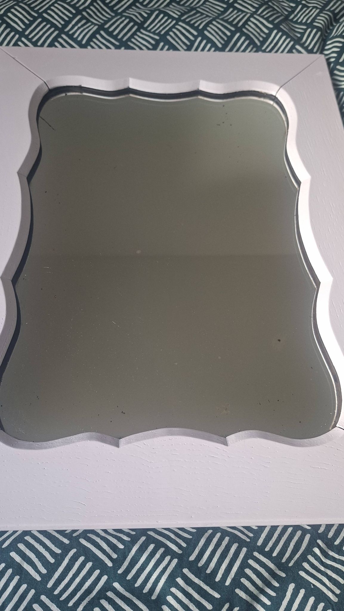 Mid-20th century rectangular wall mirror with a powder pink frame.