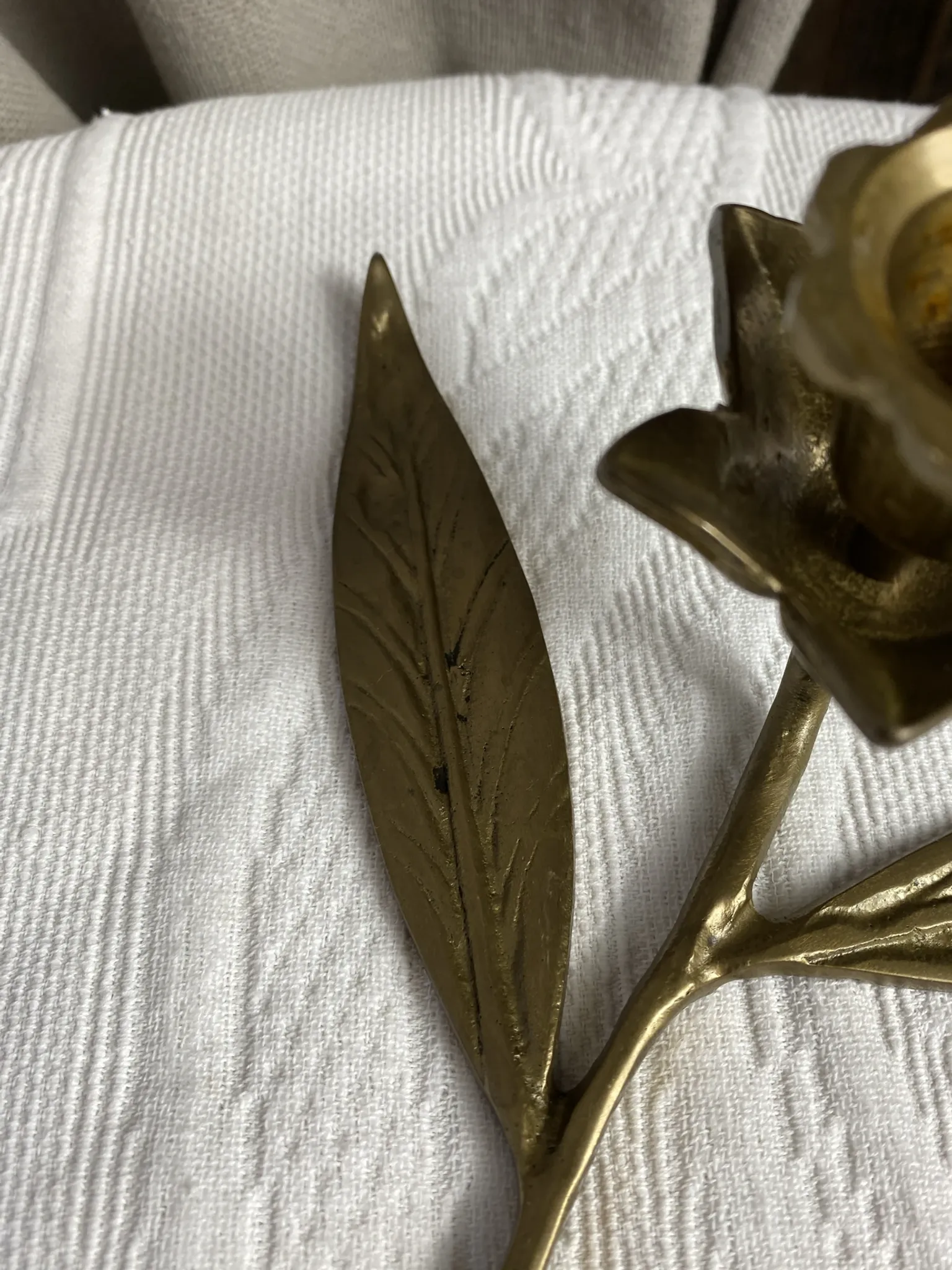 Flower candlestick and removable ashtrays in solid brass.