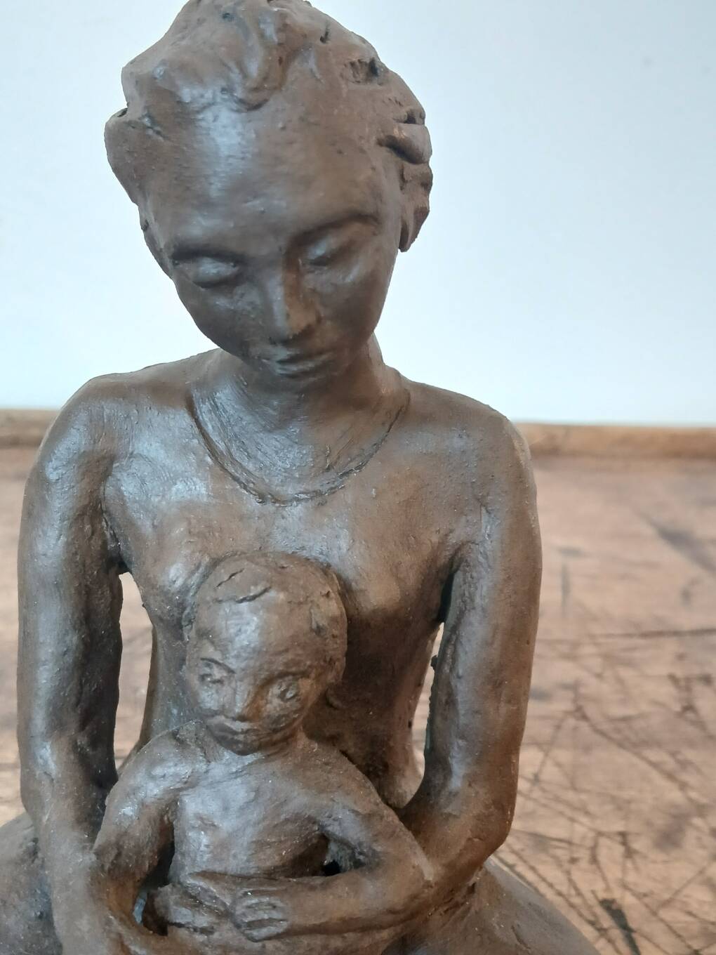 Terracotta statue of a woman with child, signed