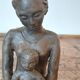 Terracotta statue of a woman with child, signed