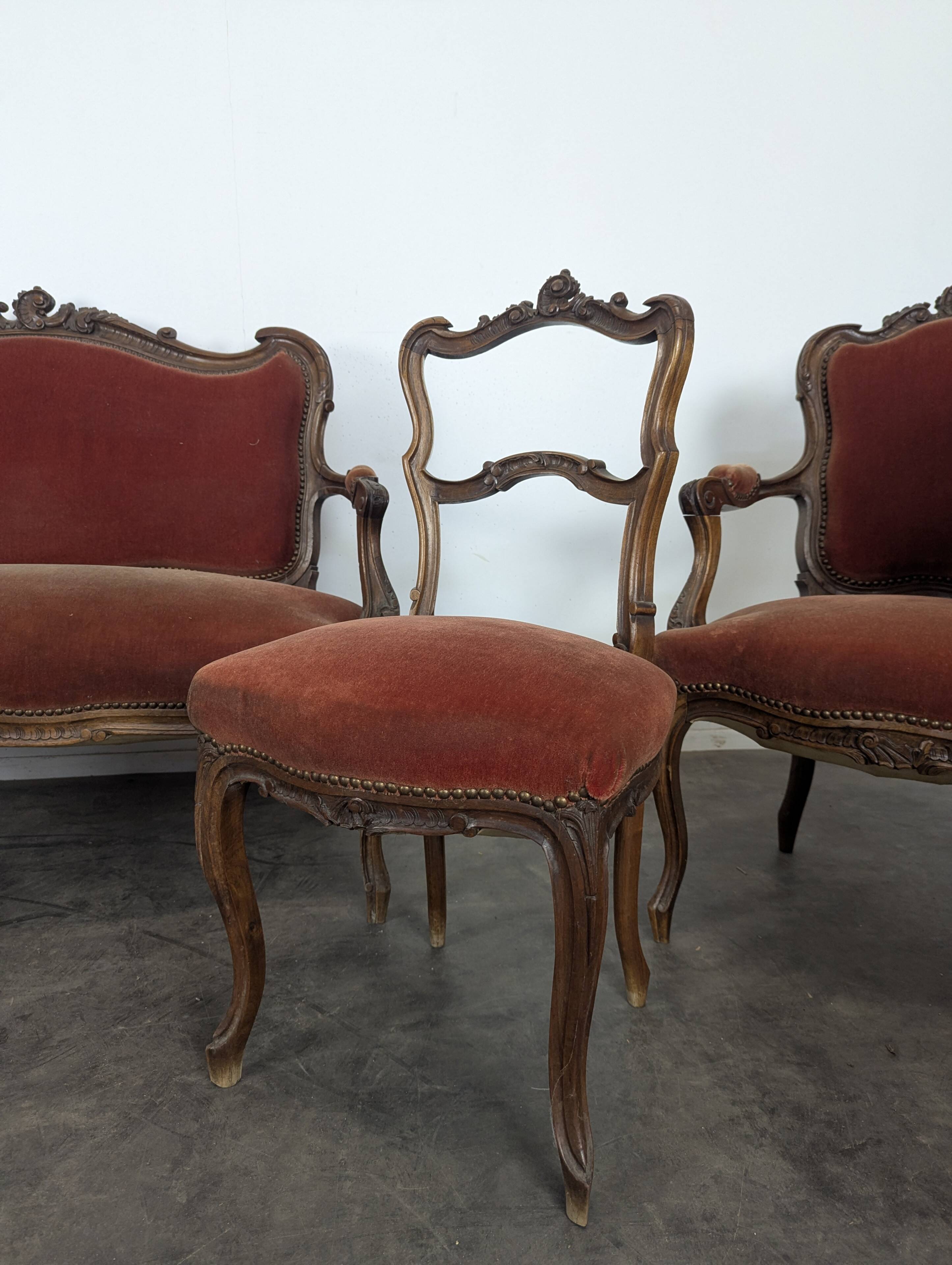 Louis XV style salon in carved walnut with orange velvet, seven pieces.
