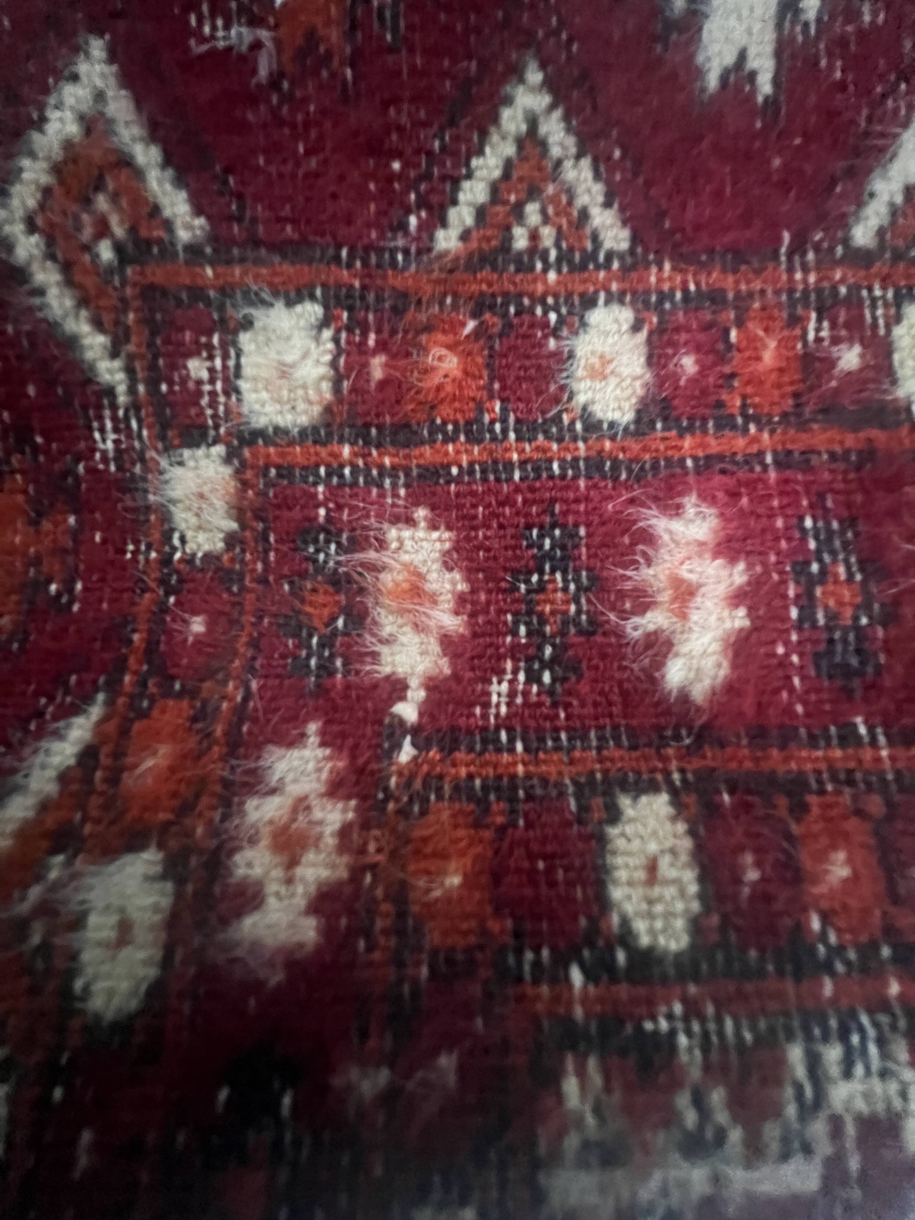 Antique wool rugs with designs on a red background, 20th century.
